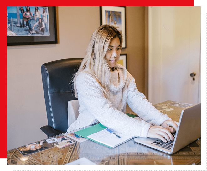 A woman sitting at her desk on the phone