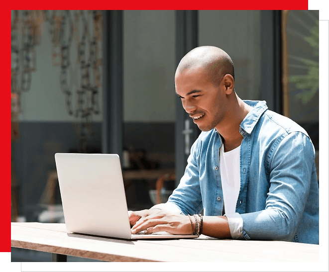 A man sitting at a table with a laptop.